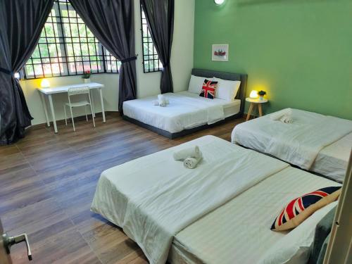 a room with two beds and a table and two windows at Semi-Detached, Up to 21 Pax, 4 Bedrooms, 3 Bathrooms, 4 Car Parks by Star Home in Bayan Lepas