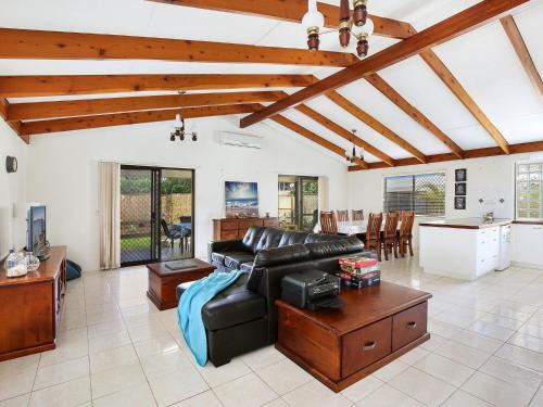 a living room with a couch and a table at Michael Street 39 Golden Beach in Caloundra