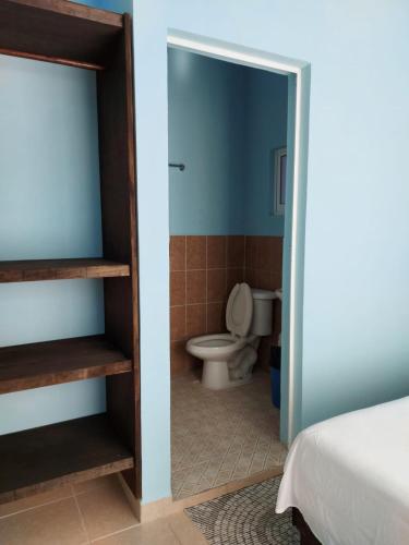a bathroom with a toilet in a room at Casa La Paz 2 in Puerto Escondido