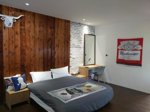 a bedroom with a bed and a wooden wall at Original Bnb in Tainan