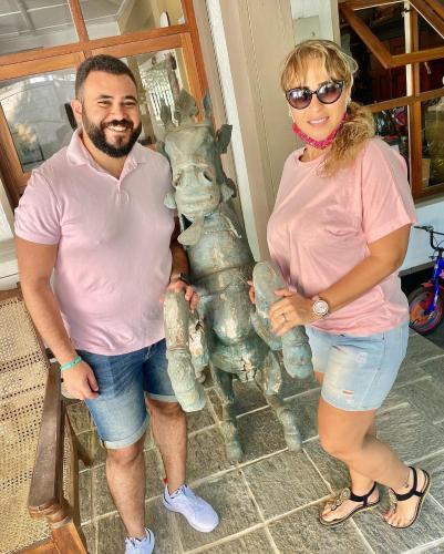 a man and a woman standing next to a statue at Settle Inn Tourist Lodge in Kandy