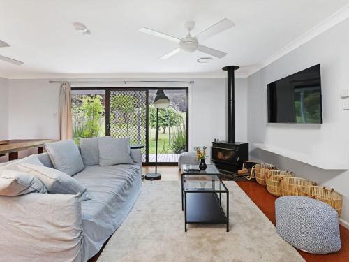 a living room with a couch and a tv at The Hamilton Kangaroo Valley in Kangaroo Valley