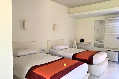 Postel nebo postele na pokoji v ubytování The Yani Hotel Bali