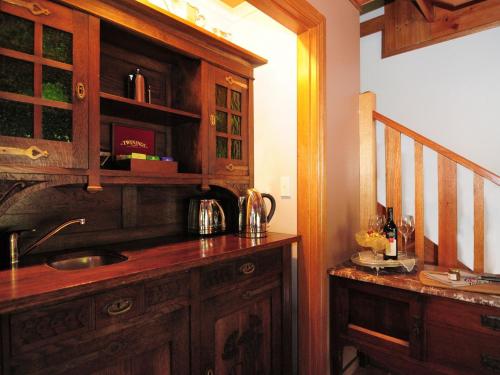 a kitchen with a sink and a wooden cabinet at Orange Blossom Retreat in Kangaroo Valley