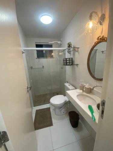 a bathroom with a shower and a toilet and a sink at Apartamento em Resort Privativo in Aracaju