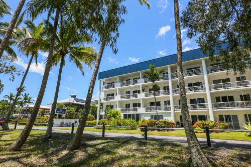 a large building with trees and a street at Agincourt Beachfront Apartments in Clifton Beach