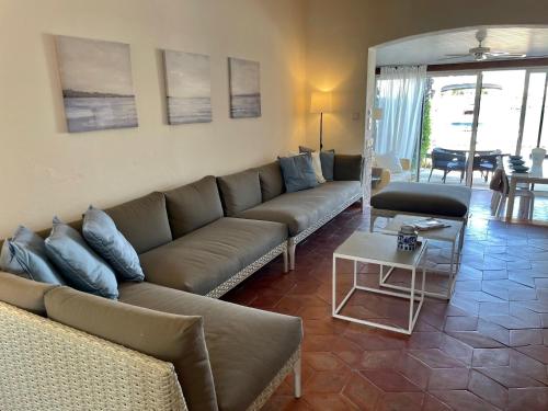 a living room with a couch and a table at Cozy villa in a charming neighbourhood in Grimaud