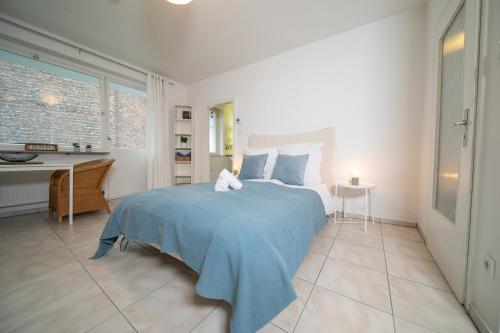 Кровать или кровати в номере Apartment Blue - Zentral und gut angebunden