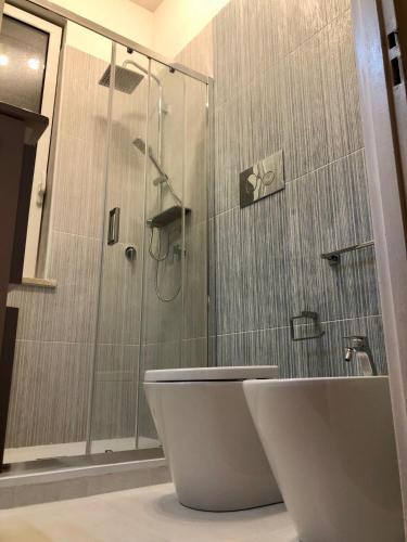 a bathroom with a shower and a toilet and a sink at Casa Kina Marsala in Marsala