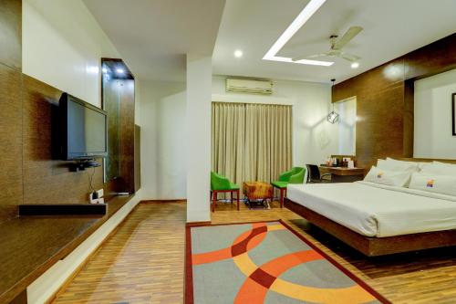 a hotel room with a bed and a flat screen tv at MySpace Forest Keys in Bangalore
