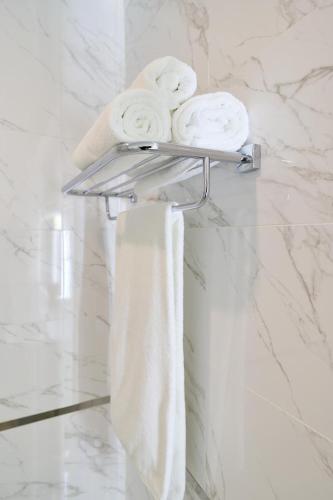a towel rack with towels on it in a bathroom at Victoria Hotel in Oral
