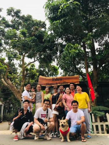 a group of people posing for a picture with a dog at Eden House & Coffee Con Dao in Con Dao