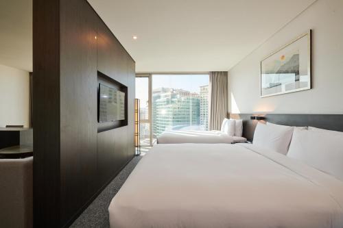 a hotel room with two beds and a large window at Nine Tree by Parnas Seoul Insadong in Seoul