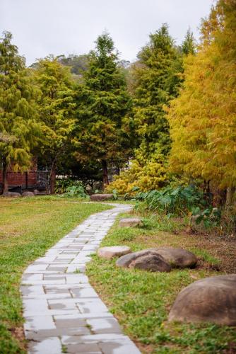 a stone path in a park with rocks at Urarakana B&B in Miaoli