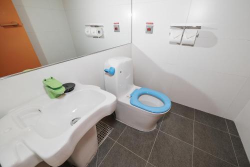 a bathroom with a white sink and a toilet at Nine Tree by Parnas Seoul Insadong in Seoul
