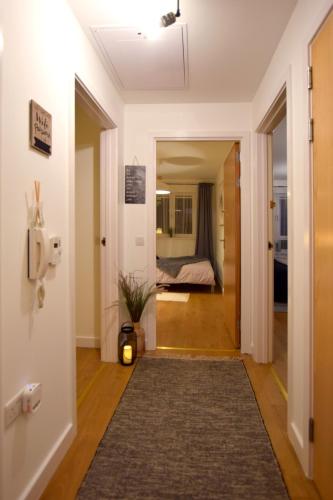 a hallway with a door leading to a bedroom at Modern 2 bed Apartment- Town Centre in Northampton
