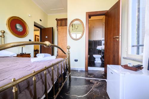 a bedroom with a bed and a bathroom with a sink at Villa Emilia in Pozzuoli