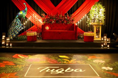 a stage with a red couch on a stage at Ramada Encore By Wyndham Istanbul Basin Express in Istanbul