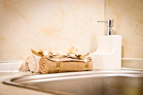 a bathroom sink with a towel and a toothbrush at Sunflower Apartment City Center in Plovdiv