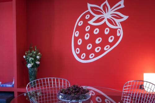 a red wall with a strawberry stencil on it at Habitat Apartments ADN in Barcelona