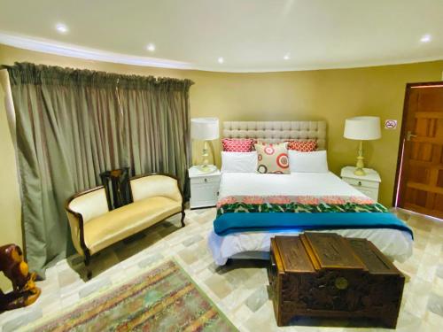 a bedroom with a bed and a chair at Country Lane Farm lodge in Cradock
