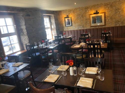 a dining room with tables and chairs in a restaurant at Scone Arms Hotel in New Scone