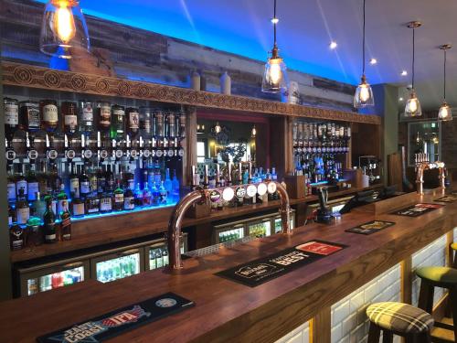 a bar with a lot of bottles of alcohol at Scone Arms Hotel in New Scone