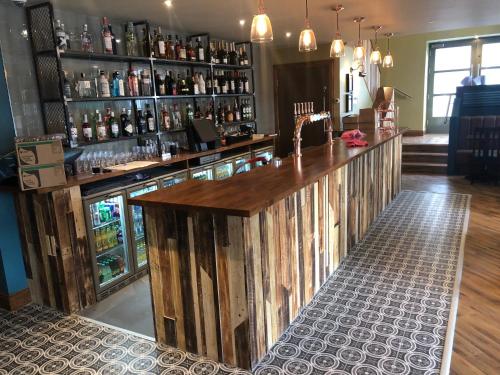 a bar with a wooden counter in a room at Scone Arms Hotel in New Scone
