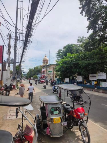 a group of motorcycles parked on the side of a street at Purple Guesthouse in Nasugbu