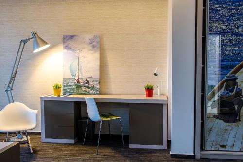 an office with a desk with a painting on the wall at Hotel On Plonge Junior in Mamaia