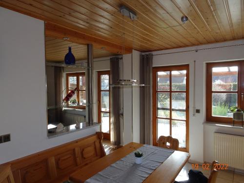 a kitchen with a wooden ceiling and a wooden table at Ferienwohnung Schwarz in Röttenbach