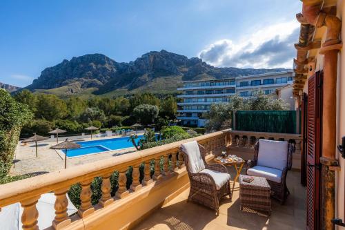 a balcony with a view of the pool and mountains at Can Petit Estel in Colonia de Sant Pere
