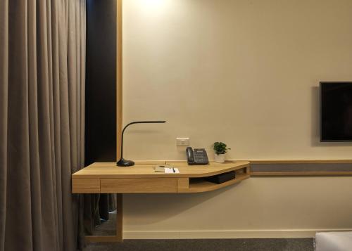a desk in a room with a telephone on it at Zazz Urban Ho Chi Minh in Ho Chi Minh City