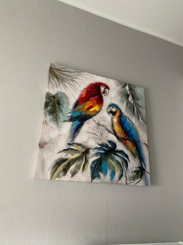 a painting of two birds on a wall at Hotel Kellermann in Overath