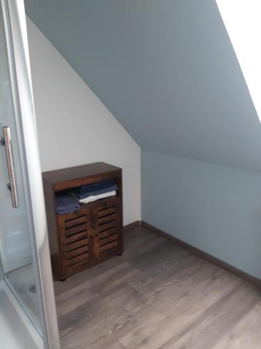 a room with a small cabinet in the corner at JaNettes Gästehaus in Bad Doberan