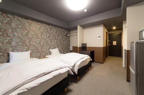 Voodi või voodid majutusasutuse Kyoto Sanjo Ohashi toas