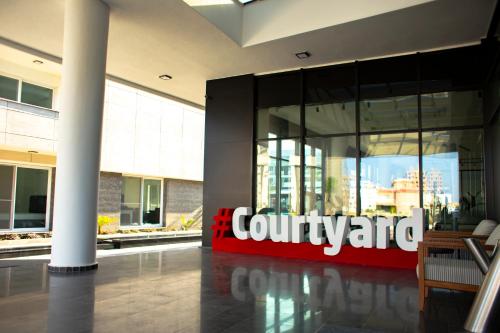 a lobby of a building with a sign on it at Courtyard Long Beach Holiday Resort in Iskele