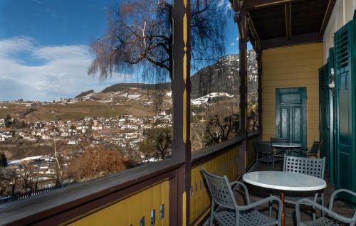 a balcony with a table and chairs and a view at Hotel Salegg in Siusi