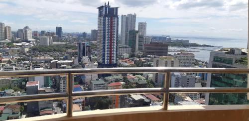 a view of a city from a balcony at Birch Tower by Tristoff in Manila
