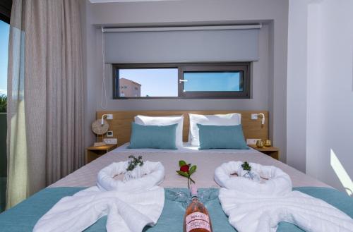 a bedroom with towels on a bed with a window at Imperium Luxury Villas-Sauna, Jacuzzi, Heated Pool & Gym-Chania in Kato Galatas