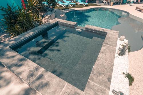 a swimming pool with a resort style swimming pool at Le President-Gare Nimes Pont Du Gard in Bellegarde