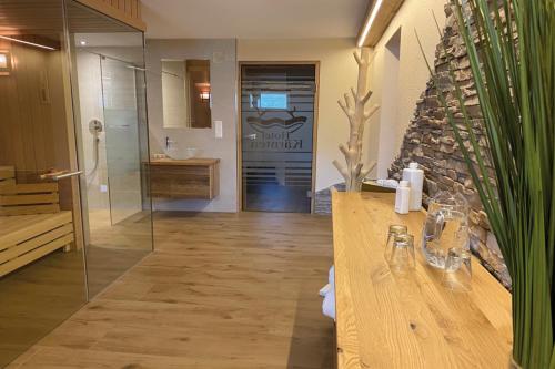 a bathroom with a shower and a counter with a sink at Hotel Kärnten in Krumpendorf am Wörthersee