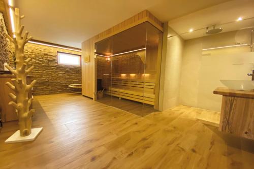 a bathroom with a shower and a sink and a mirror at Hotel Kärnten in Krumpendorf am Wörthersee