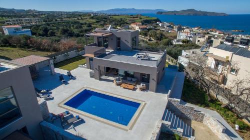 an aerial view of a house with a swimming pool at Imperium Luxury Villas-Sauna, Jacuzzi, Heated Pool & Gym-Chania in Kato Galatas