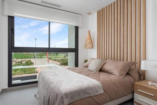 a bedroom with a bed and a large window at Quesada sun rojales in Rojales