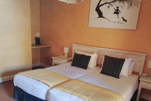 a bedroom with a large bed with two pillows at At SILVER PALMS in Tzaneen