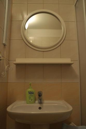 a bathroom sink with a mirror on the wall at Privat Podlesom in Kežmarok