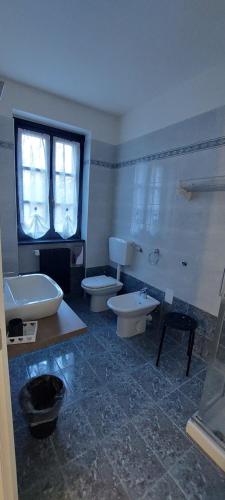 een badkamer met 2 wastafels en 2 toiletten bij Eden Guest House Colico in Colico