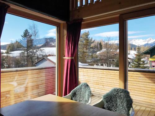 a room with a table and chairs and a large window at Bio Ferienwohnung am Wildsee in Seefeld in Seefeld in Tirol