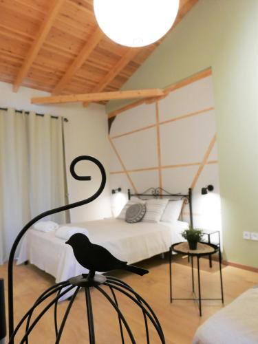 a black bird sitting on a chair in a bedroom at Fox Tale Guest House in Fternón
